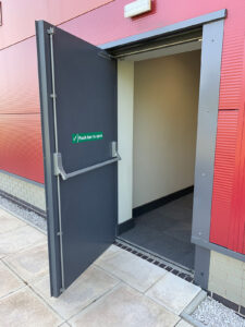 An open ArrowSecure Fire Door installed in a commercial building by Arrow Industrial